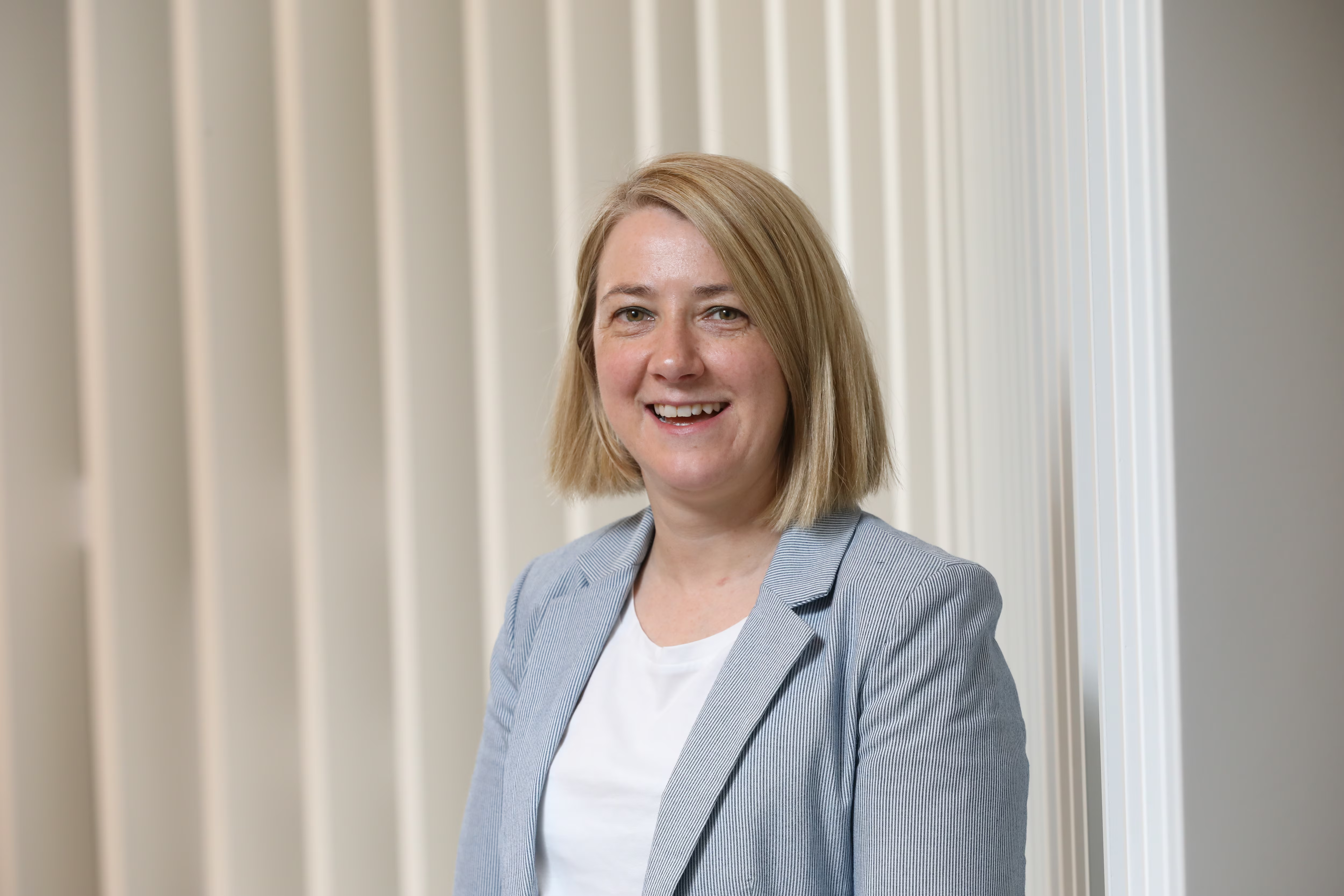 Sinead, Senior Director of Engineering, smiling in an office setting