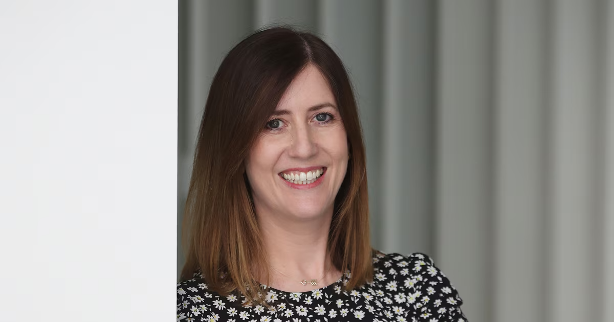 Claire, Director of Engineering, smiling in an office setting