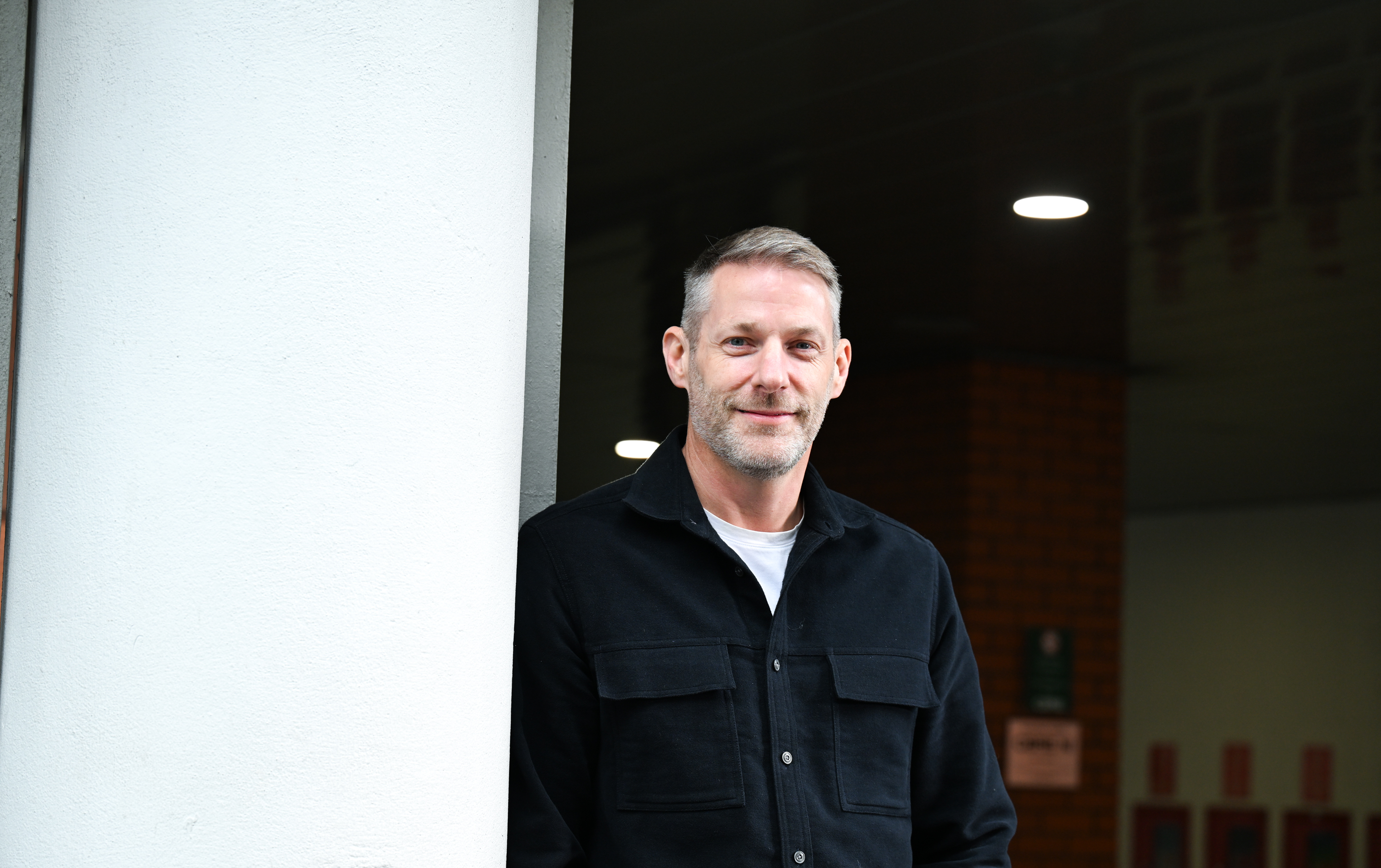 Stuart smiling in an office setting