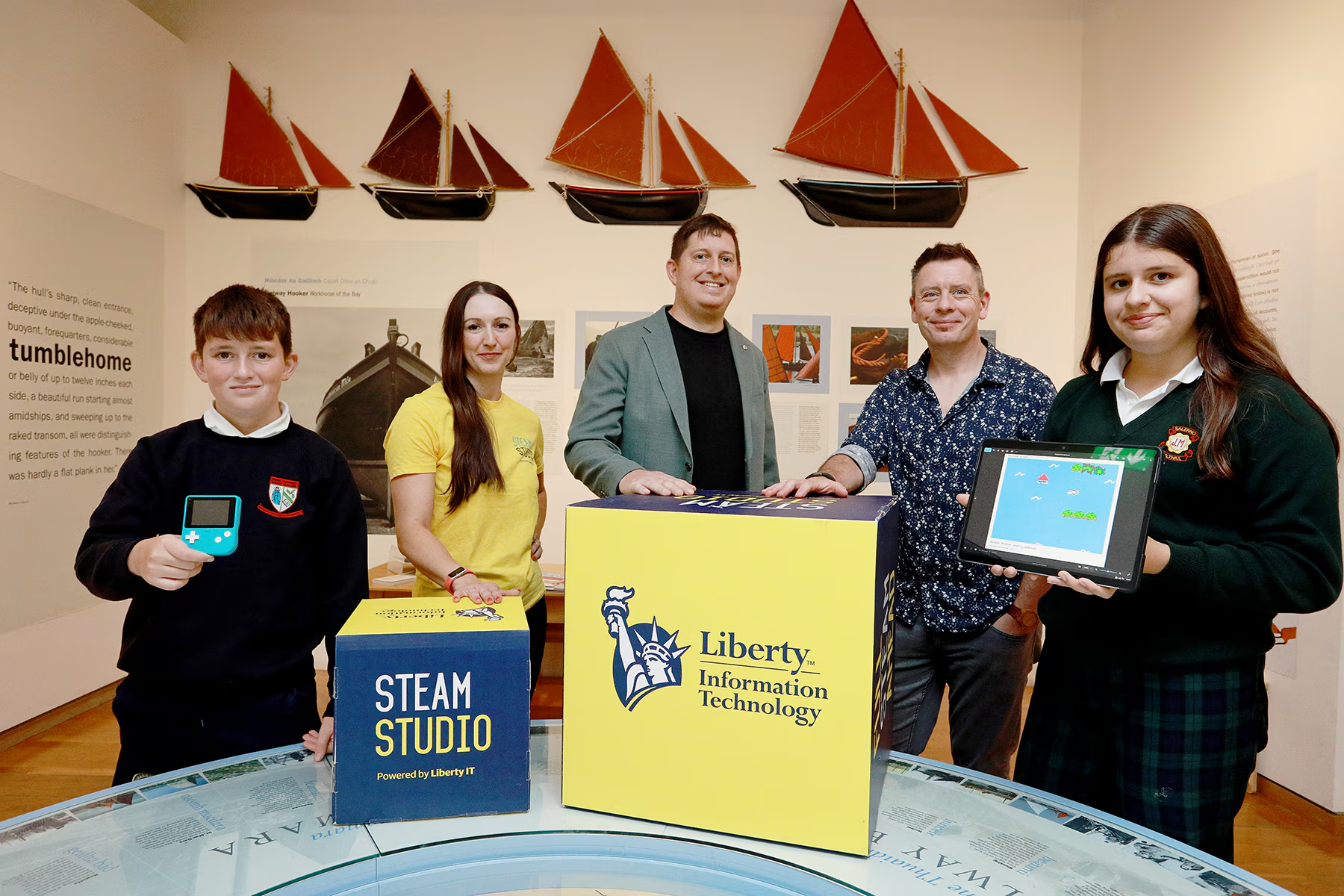 Five people in Galway City Museum with STEAM Studio advertising