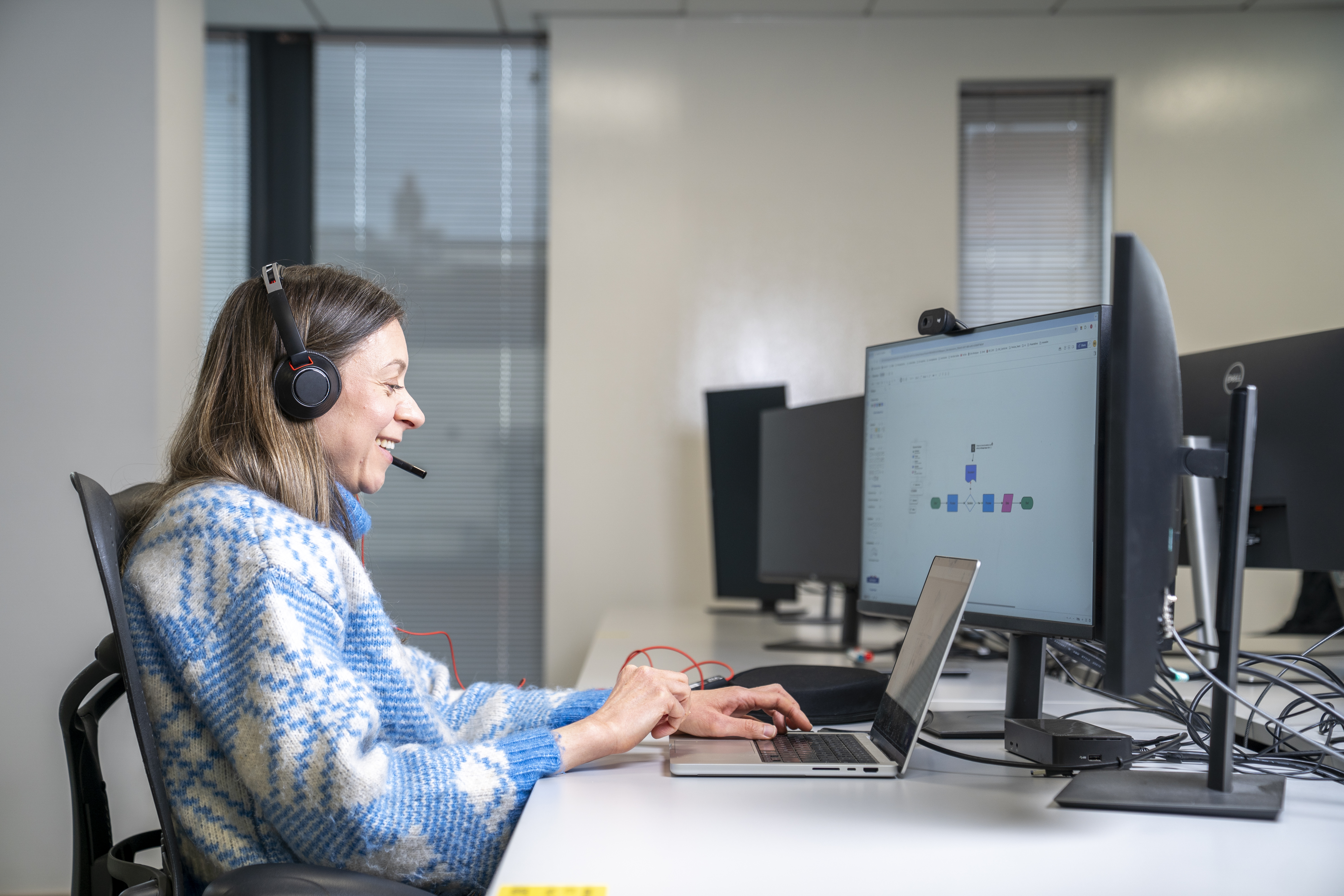 Employee joining an online meeting from a Liberty IT office.