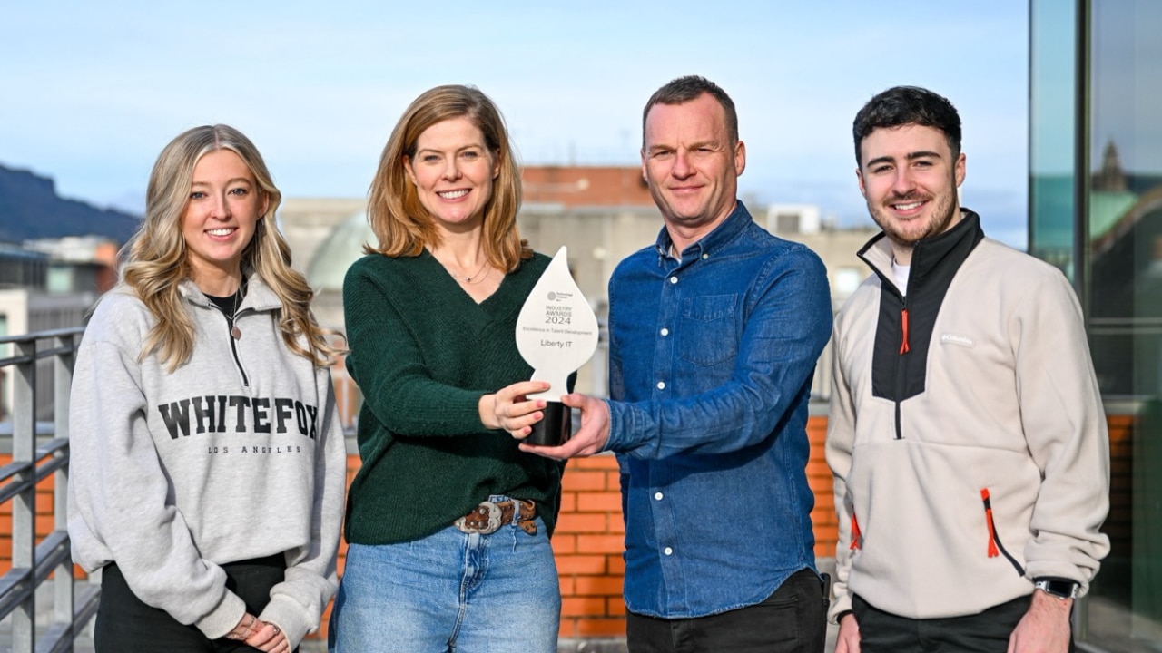 Group of four individuals holding a Technology Ireland trophy